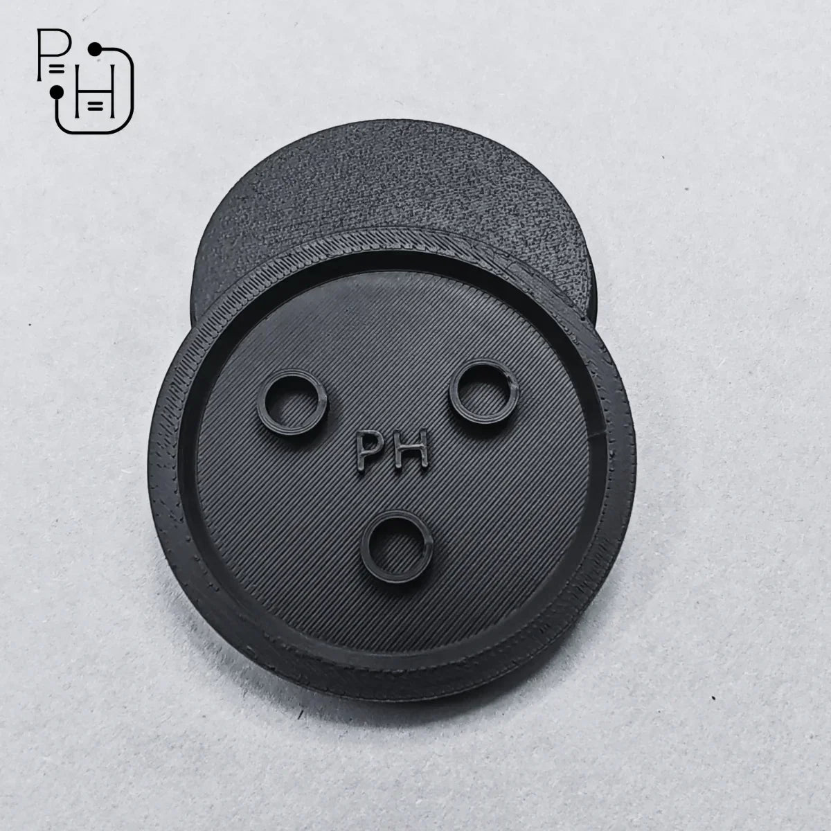 Black 3D printed wargaming base with PH logo and three pin holes for miniatures