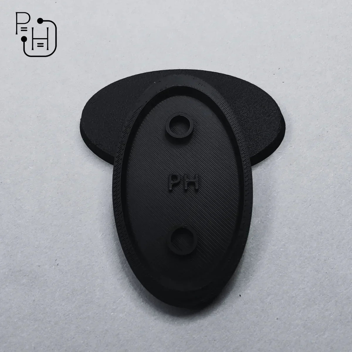 Black 3D printed wargaming base with PH logo, textured surface, and mounting holes for miniatures