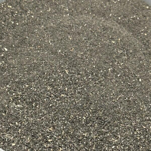 Close-up of dark grey coarse grit scenery material for wargaming miniatures