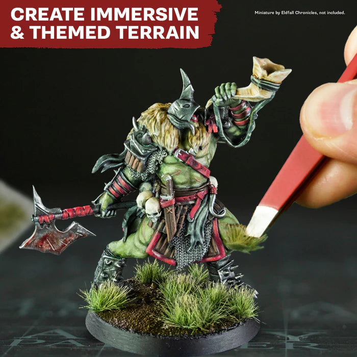 Painted orc wargaming miniature with axe on grassy base, themed terrain for immersive tabletop battles