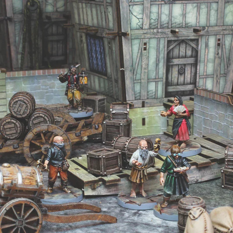 Painted wargaming miniatures in medieval tavern scene with barrels, crates, and detailed figures for hobbyists