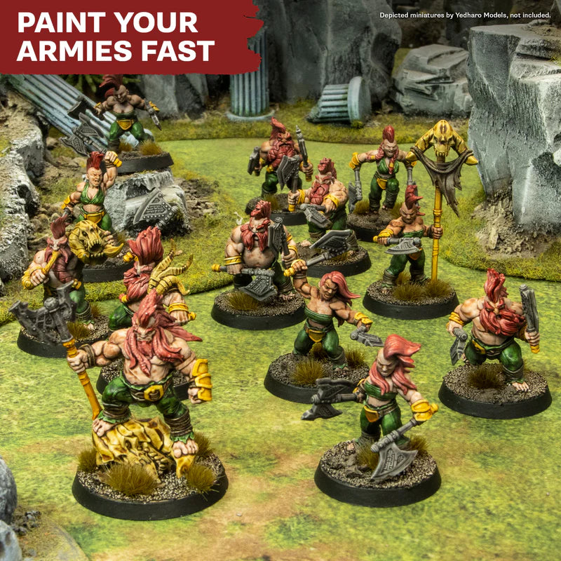 Painted wargaming miniatures with vibrant red hair and green armor on grassy terrain